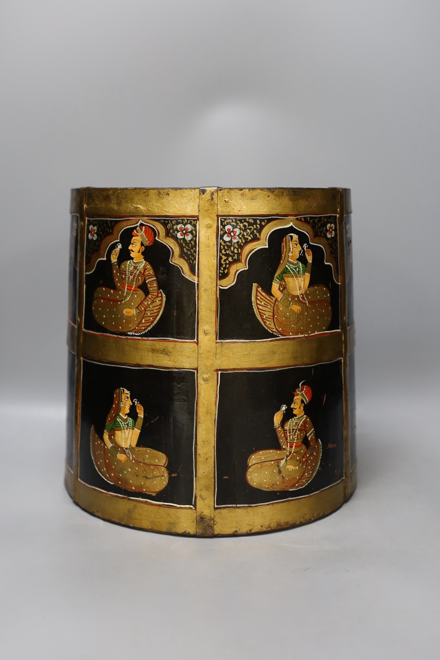 An African carved wood bowl, a Tibetan prayer wheel and a Persian waste basket